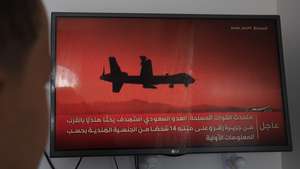 epa13322230 A person follows television coverage of the Saudi-Houthi conflict in Sanaa, Yemen, 22 October 2026. Houthi military spokesman Yahya Sarea said the group had carried out four missile and drone attacks on Saudi positions.  EPA/YAHYA ARHAB