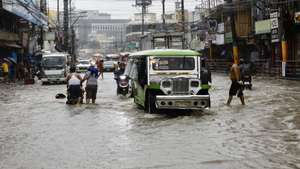 epa11579033 Motorists wade along a flooded road in Bacoor city, Cavite province, about 30 kilometers south-east of Manila, Philippines, 02 September 2024. In a report by the National Disaster Risk Reduction and Management (NDRRMC) on 02 September, two people were dead and scores injured as a result of conditions brought by Tropical Storm Yagi. The state weather agency of the Philippines warned residents living along the typhoon path to take precautionary measure due to possible flash floods in low-lying areas and landslides in mountainous villages.  EPA/FRANCIS R. MALASIG