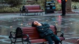 epa10861287 A man naps on a bench in a park, in Shanghai, China, 14 September 2023 (issued 15 September 2023). China's unemployment rate fell to 5.2 percent in August 2023, from 5.3 percent in July, according to a report from the National Bureau of Statistics. Last month, China suspended releasing the youth unemployment rate data after six consecutive increases. The National Bureau of Statistics reported the surveys need further optimisation and improvement.  EPA/ALEX PLAVEVSKI