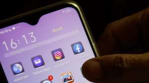 epa08624241 A Facebook application icon (R) is seen on a mobile phone in Bangkok, Thailand, 25 August 2020. Facebook announced preparations for legal action against the Thai government after it demanded the social media platform to block users within Thailand to access the one million members of the 'Royalist Marketplace' Facebook group alleged of critical the king. The 'Royalist Marketplace' Facebook group was created by a Thai self-exiled academic and monarchy critic, Pavin Chachavalpongpun who is currently working as an associate professor in Japan.  EPA/RUNGROJ YONGRIT