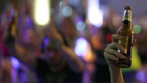 epa07073750 Yoga enthusiast holds up a drinks bottle as attend the Brew Yoga class during the Silent Brew Yoga in Bangkok, Thailand, 06 October 2018. The Silent Brew yoga is the yoga combines the joy of drinking with drinks both have alcoholic and non-alcoholic during traditional yoga poses by balancing the bottle of drinks on yogis' bodies and sip the drinking beverage for immerse yourself in the motion of yoga with a pair of noise isolating wireless headphones for takes on a musical journey into sound.  EPA/NARONG SANGNAK