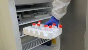 epa08387828 A Kenyan laboratory technologist in protective clothing gets polymerase chain reaction (PCR) samples from a freezer before testing them at the main laboratory, where tests for SARS-CoV-2 coronavirus which causes the COVID-19 disease are conducted for suspected cases, in Machakos county at the Machakos Level 5 hospital in Machakos, Kenya, 27 April 2020. Machakos county is offering COVID-19 screening and testing to anyone who has symptoms or believes he or she has been infected.  EPA/Daniel Irungu