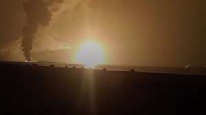 epa12038085 A handout screen grab taken from a video released by Houthis-run al-Masirah TV shows flames and smoke rising from the fuel port of Ras Isa following US airstrikes, in the port province of Hodeidah, Yemen, 18 April 2025. At least 22 people were killed and more than 50 others injured as a result of US airstrikes that targeted the fuel port of Ras Isa on the coast of the Red Sea, in the Yemeni province of Hodeidah, Houthis-run al-Masirah TV has reported.  EPA/HOUTHIS AL-MASIRSAH TV / HANDOUT BEST QUALITY AVAILABLEHANDOUT EDITORIAL USE ONLY/NO SALES