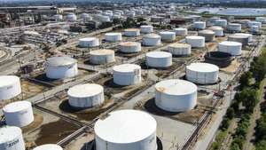 epa07803127 An aerial view taken with a drone shows oil storage tanks at the BP oil refinery in Whiting, Indiana, USA, 29 August 2019. The facility has the capability of handling 400,000 barrels of crude oil per day and it is the sixth largest oil refinery in the USA. Standard Oil of Indiana first established the refinery in 1889.  EPA/TANNEN MAURY