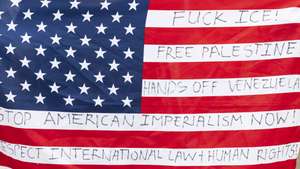 epa12653190 The US flag is seen during a demonstration outside the US Embassy in solidarity with the people of Venezuela, in Johannesburg, South Africa, 16 January 2026. Added to their call not to get politically involved in the affairs of Venezuela, they also called for the freedom of Palestine.  EPA/Kim Ludbrook