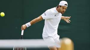 epa10038521 Joao Sousa of Portugal hits a backhand in the men's first round match against Richard Gasquet of France at the Wimbledon Championships, in Wimbledon, Britain, 28 June 2022.  EPA/TOLGA AKMEN   EDITORIAL USE ONLY