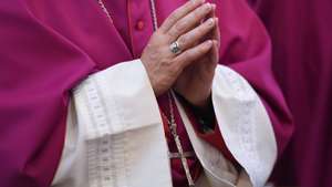 epa04943219 A member of the German Bishops' Conference with his hands folded for prayer during the opening church service at the autumn conference of the clerical institution in the cathedral of Fulda, Germany, 22 September 2015. The Catholic bishops will discuss the ongoing refugee crisis in Europe among other issues during the traditional meeting.  EPA/ARNE DEDERT