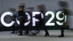 epa11730467 Participants pass light letters at the United Nations Climate Change Conference COP29 in Baku, Azerbaijan, 20 November 2024. The Azerbaijani capital of Baku hosts the 2024 United Nations Climate Change Conference (COP29) from 11 to 22 November 2024.  EPA/ANATOLY MALTSEV