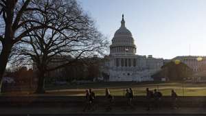 epa08925022 Members of the District of Columbia National Guard walk past the grounds of the US Capitol in Washington, DC, USA, 07 January 2021. Members of Congress certified the 2020 Electoral College early this morning following more than 6 hours of suspension on Wednesday as a result of  supporters of US President Donald J. Trump storming into the US Capitol following a rally with the President on the National Mall.  EPA/JUSTIN LANE