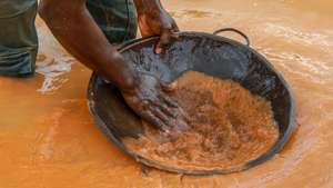 epa10691289 A miner pans for gold in an illegal mining operation in Abomosu, Ghana, 14 June 2023. Ghana, situated in West Africa, has reclaimed its position as Africa&#039;s top gold producer as the output increased from 2.82 million ounces in 2021 to 3.74 million ounces in 2022.  EPA/CHRISTIAN THOMPSON