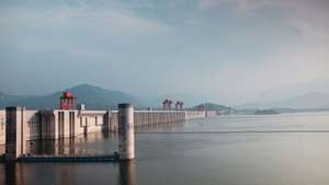 epa12122692 A photo taken during an organized media tour shows the Three Gorges Dam on the Yangtze River in Yichang, Hubei province, China, 21 May 2025. The Three Gorges Dam, which measures 185 meters in height and 2,309 meters in width, became fully operational in 2012. It is the world's largest power station by installed capacity, generating 22,500 MW. The dam produces approximately 95±20 TWh of electricity.  EPA/ALEX PLAVEVSKI
