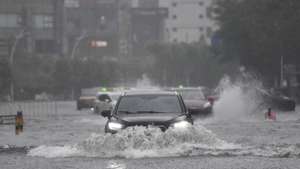 epa12249767 Vehicles drive through a flooded area in Haikou, Hainan Province, China, 20 July 2025. Typhoon Wipha, the sixth typhoon of the year, made landfall near Jiangmen City in south China's Guangdong Province around 5:50 p.m., according to the Guangdong provincial meteorological observatory. Hainan raised its emergency response for flood and typhoon control from Level IV to Level III, as strong winds and rainstorms are expected to impact the island province.  EPA/XINHUA / Yang Guanyu CHINA OUT / UK AND IRELAND OUT  /       MANDATORY CREDIT EDITORIAL USE ONLY
