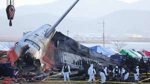 epa11799472 A police forensic team conducts an on-site investigation at the scene of the 29 December Jeju Air passenger plane crash at Muan International Airport in Muan, South Korea, 31 December 2024.  EPA/YONHAP SOUTH KOREA OUT