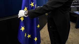 epa07286224 An usher places the european flag at the European Parliament in Strasbourg, France, 15 January 2019, after the 	 commemoration of twenty years of the Euro.  EPA/PATRICK SEEGER