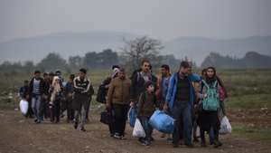 epa12347932 (FILE) - Migrants walk to the registration camp after they cross the border between Greece and Macedonia, near the city of Gevgelija, The Former Yugoslav Republic of Macedonia, 24 September 2015 (reissued 03 September 2025). The 2015 European migrant crisis refers to a large-scale arrival of refugees and migrants, especially from the Middle East, to Europe. The crisis reached a peak in terms of public visibility, humanitarian challenges and political responses early September: 1 September, thousands of refugees were stranded at the Budapest’s Keleti railway station; 2 September, the photo of two-years old Alan Kurdi washed up on a Turkish beach became a powerful symbol of the crisis; 05 September, Germany and Austria jointly allowed refuges to cross their borders and apply for asylum. Angela Merkel’s decision to allow refugees into Germany marked a significant turning point, temporarily waiving the European Dublin Regulation. Her famous statement, "We can do this" (Wir schaffen das), is directly tied to this moment.  EPA/GEORGI LICOVSKI *** Local Caption *** 52242275