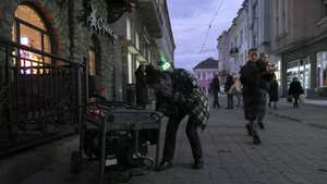 epa11775574 A person operates a generator amid a power cut in Uzhgorod, Western Ukraine, 13 December 2024. Power cuts have been reported across Ukraine after Russian forces launched a large-scale country-wide attack on the night between 12 and 13 December 2024, with around 90 missiles and 190 unmanned aerial vehicles (UAVs), according to Ukrainian President Zelensky.  EPA/IGOR TKACHENKO