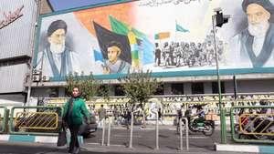 epa12449986 Iranians walk past a wall painting of Iranian Supreme Leader Ayatollah Ali Khamenei (Top-L) and late Iranian Supreme Leader Ayatollah Ruhollah Khomeini (Top-R) in Tehran, Iran, 13 October 2025. According to the Iranian Foreign Ministry, the country decided not to participate in the Gaza (Sharm el-Sheikh) Summit, adding that 'as long as the right of self-determination for Palestinians is not realized, we cannot be hopeful about solving the issue.'  EPA/ABEDIN TAHERKENAREH