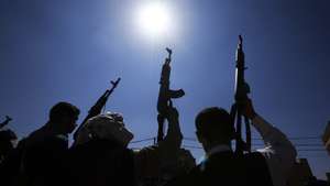 epa13286971 Houthi fighters hold up their weapons during a campaign to mobilize more fighters, in Sana'a, Yemen, 07 October 2026. As fighting between the Houthis and the Saudi-led coalition escalates, the head of Yemen's internationally recognized government, Rashad al-Alimi, announced in an address on 04 October the launch of military operations to retake remaining territory held by the Houthis.  EPA/YAHYA ARHAB