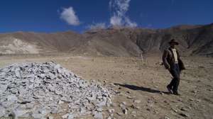 epa01681621 A Tibetan ethnic man passes by stones which were discarded from a truck of stone pit in Najin, in the rural area of Lhasa, China's Tibet, 29 March 2009. The Tibet Autonomous Region of China is located in the southwest part of the Qinghai-Tibet Plateau. It borders on Sichuan and Yunnan provinces to the east, Qinghai and Xinjiang to the north, and shares borders with India, Nepal, Sikkim, Bhutan and Burma to the south, and is bounded by Kashmir to the west.  The region covers more than 1.2 million square kilometers, accounting for one eighth of China's total land mass, and ranking second in China. Tibet has various complex landforms such as high and steep mountains, deep valleys, glaciers, bare rocks and gobi deserts. All places in the region lie at an average altitude of more than 4,000 meters. Tibet has a population of 2.61 million, 92.2 per cent of whom are Tibetans, or 2.41 million.  EPA/NG KONG