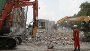 epa12059895 A rescue worker clears the debris at the collapsed building in Sagaing, Myanmar, 28 April 2025. A 7.7-magnitude earthquake struck the country on 28 March, severely impacting six regions and states, resulting in over 3,600 deaths, thousands injured, and 145 still missing, according to the Myanmar government.  EPA/NYEIN CHAN NAING