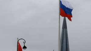 epa11976092 A large-scale national flag of Russia (R) and the flag of the former Soviet Union (L) wave from the coast of the Gulf of Finland with the business tower Lakhta Centre, the headquarters of Russian gas monopoly Gazprom in the background, in St. Petersburg, Russia, 20 March 2025. Temperatures in St. Petersburg, Russia's second largest city, reached five degrees Celsius on the day.  EPA/ANATOLY MALTSEV