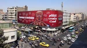 epa13178257 Iranians drive near an anti-Trump billboard in Tehran, Iran, 19 August 2026. Iranian parliament speaker Mohammad Bagher Ghalibaf said that the Strait of Hormuz will remain closed until the United States lifts its blockade and ends sanctions.  EPA/ABEDIN TAHERKENAREH RESTRICTIONS: NO Access Israel Media/Persian Language TV Stations Outside Iran/Strictly No Access BBC Persian/VOA Persian/Manoto TV/Iran International TV. (As mandated by Iran's Directorate General for Foreign Media) --
