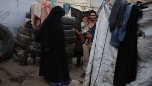 epa12802454 Displaced people stand next to their shelter at a makeshift camp for Internally Displaced Persons (IDPs) in Sana'a, Yemen, 07 March 2026. The World Food Programme (WFP) has warned of an escalating food security crisis in Yemen, with 63 percent of households nationwide struggling to meet their minimum food needs.  EPA/YAHYA ARHAB