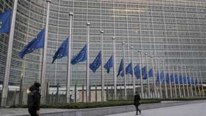 epa09678435 European flags are lowered to half mast in front of the seat of the European Commission in commemoration of late European Parliament President David Sassoli, at EU headquarters in Brussels, Belgium, 11 January 2022. David Sassoli, the Italian journalist who worked his way up in politics and became president of the European Union's parliament, died at a hospital in Italy early 11 January 2022, his spokesperson said.  EPA/OLIVIER HOSLET