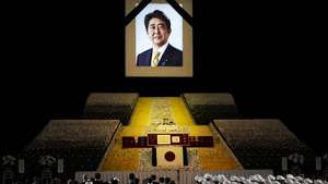epa10364977 epa10208695 A portrait of former Japanese Prime Minister Shinzo Abe hangs on the stage during the state funeral of former Japanese Prime Minister Shinzo Abe at Nippon Budokan in Tokyo, Japan, 27 September 2022. Thousands of people are gathered in Tokyo to attend the state funeral for former prime minister Shinzo Abe, including foreign dignitaries and representatives from more than 200 countries and international organizations.  EPA/FRANCK ROBICHON / POOL  EPA-EFE/FRANCK ROBICHON / POOL