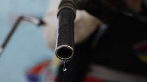 epa10251026 An attendant holds a fuel nozzle after pumping fuel into a vehicle at a gasoline station in Sana'a, Yemen, 18 October 2022. The Houthis-controlled petroleum authority has cut retail price of gasoline from 575 to 525 Yemeni rials per one litter (from one euro to 0.95 euro per one litter) in the northern Yemeni provinces under its control, in line with the global decline in oil prices as well as the flow of fuel imports into the Houthis-held ports.  EPA/YAHYA ARHAB