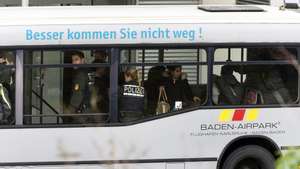 epa04521550 Denied asylum seekers are transported on an airport bus with the slogan roughly translating to &#039;You will find no better way to leave!&#039; with police officers to be taken to their flight as part of a Baden-Wuerttemberg-wide collective deportation at Baden Airport in Rheinmuenster, Germany, 09 December 2014. Some 80 refugees whose asylum applications were rejected will be returned to Belgrade, Serbia and Skopje, Macedonia from Karlsruhe/Baden-Baden Airport.  EPA/DANIEL MAURER