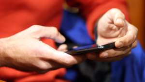 epa11796284 A man uses his smartphone while sitting in a cafe in Tehran, Iran, 28 December 2024. The Iranian government on 27 December 2024 unblocked Whatsapp and Google Play after two years, while the rest of the social media such as Telegram, Instagram, X and YouTube remain blocked.  EPA/ABEDIN TAHERKENAREH