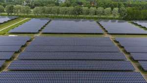 epa09938355 An aerial view taken by a drone of the Solar Park Biddinghuizen, the Netherlands, 10 May 2022. The parking lots of the Lowlands festival are fully equipped with solar panels. The solar park with an area of 35 hectares is the largest solar carport in the world.  EPA/Vincent Jannink