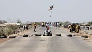 epa10622751 A South Sudan national flag and tires mark the road for refugees and returnees to find the International Organization for Migration (IOM) registration point, Wunthaou, South Sudan, 12 May 2023. Fleeing the armed conflict between the Sudanese military and the RSF (Rapid Support Forces) militia which started last 15 April, some 40 000 people have arrived into South Sudan according to the UNHCR. Most of the refugees are part of the some 800 000 South Sudanese who had fled the war in South Sudan in the first place and they are returning to a country which is barely out of conflict itself with tensions still remaining in many areas and more than 2 million internally displaced people. The scarcity of food and water and the military escalation had made the stay of most civilians impossible in Sudan. Upon arriving at Joda border crossing the refugees head to a transit area set up by the UNHCR in the small town of Renk, where various UN agencies assist them with registration, food, health check and logistics to either leave Renk which is not equipped to house a large refugee population.  EPA/AMEL PAIN
