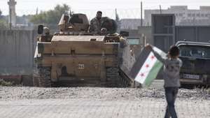 epa07929467 Turkish-backed Syrian fighters drive armored vehicles from Northern Syria for a military operation in Kurdish areas, near the Syrian border, in Akcakale district in Sanliurfa, Turkey, 18 October 2019. The USA and Turkey have reached a deal to suspend a Turkish military offensive in northern Syria for 120 hours, demanding Kurdish forces to withdraw from a designated 'safe zone' on the northern border.  EPA/ERDEM SAHIN