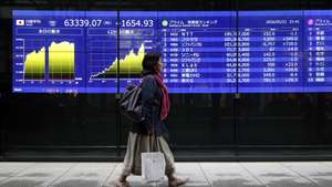 epa12983253 A passerby walks past a stock market indicator board in Tokyo, Japan, 22 May 2026. The benchmark Nikkei average surged for a second straight session, gaining 1,654.93 points to close the week at 63,339.07, reaching a new all-time high.  EPA/FRANCK ROBICHON