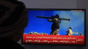 epa13250472 A person watches a TV broadcast on the latest developments in the Saudi-Houthi conflict, in Sana'a, Yemen, 19 September 2026. Yemen's Houthis claimed to have launched two missile-drone attacks targeting the Saudi capital, Riyadh, and an Aramco facility in the Red Sea Saudi city of Yanbu, amid an escalating conflict between the two sides, according to a statement by Houthi military spokesman Yahya Sarea.  EPA/YAHYA ARHAB