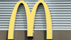 epa10559005 The McDonald’s Golden Arches on the side of the restaurant in Hutto, Texas, USA, 04 April 2023. McDonald’s has started closing corporate offices as they wait for layoffs to begin.  EPA/ADAM DAVIS