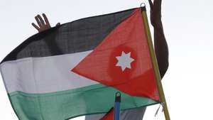 epa02918316 A Jordanian protester shouts anti-Israeli slogans behind a Jordanian flag as hundreds of Jordanians protest near Israeli embassy in Amman, Jordan, 15 September 2011. Israel evacuated its embassy in Amman late 14 September night, after calls by Jordanian activists for a 'million man march' near the embassy building.  EPA/JAMAL NASRALLAH