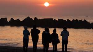 epa09816518 Visitors watch the sunrise in prayers for victims on Arahama beach in Sendai, Miyagi Prefecture, northern Japan, 11 March 2022. This date marks the 11th anniversary of the magnitude 9.0 earthquake and tsunami devastating Tokyo Electric Power Company's Fukushima Daiichi Nuclear Power Plant in 2011. According to the National Police Agency, 15,900 people have died and 2,523 are still missing. Miyagi Prefecture have announced that 1,215 people are missing in the prefecture and 211 of them only in Minamisanriku. In Iwate Prefecture, 1,110 people are still missing.  EPA/JIJI PRESS JAPAN OUT EDITORIAL USE ONLY/  NO ARCHIVES