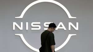 epa12095498 A visitor walks past the logo of Nissan Motor at the carmaker's headquarters' showroom in Yokohama, Japan, 13 May 2025. In April 2025 Nissan released a statement saying that it has significantly lowered its financial forecast for the fiscal year ending March 31, 2025. In addition, Nissan anticipates a net loss of 700-750 billion yen for the current fiscal year ending March 31, 2024.  EPA/FRANCK ROBICHON