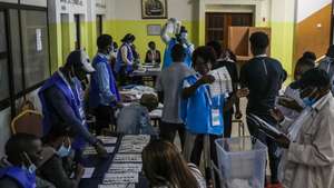 Election officials count the votes after the polls closed in the general elections at a polling station in Luanda, Angola, 24 August 2022. The general elections will define the composition of parliament and the names of the President and Vice President of the Republic. PAULO NOVAIS/LUSA