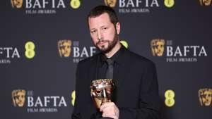 epa11164744 Mstyslav Chernov poses with the Documentary Award for '20 Days in Mariupol' in the press room during the BAFTA Film Awards at the Royal Festival Hall in London, Britain, 18 February 2024. The ceremony is hosted by the British Academy of Film and Television Arts (BAFTA).  EPA/ANDY RAIN