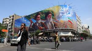 epa13027709 Iranians walk past a large billboard featuring late Iranian Supreme Leader Ayatollah Ruhollah Khomeini and Supreme Leader Ayatollah Ali Khamenei on a street in Tehran, Iran, 10 June 2026. According to US Central Command (CENTCOM), self-defense strikes were carried out against Iran near the Strait of Hormuz on 09 June in response to the downing of a US Army Apache helicopter.  EPA/ABEDIN TAHERKENAREH RESTRICTIONS: NO Access Israel Media/Persian Language TV Stations Outside Iran/Strictly No Access BBC Persian/VOA Persian/Manoto TV/Iran International TV. (As mandated by Iran's Directorate General for Foreign Media) --