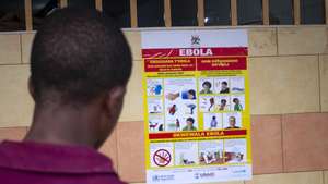 epa10212386 A man looks at an Ebola virus disease awareness campaign poster following an outbreak of Ebola in Uganda, in Kampala, Uganda, 28 September 2022. According to Uganda&#039;s Health Ministry, Ebola infections have risen across some districts in Uganda with the number of confirmed and suspected deaths at 36. The president addressed the nation on measures the government is putting in place to mitigate the spread.  EPA/Stringer