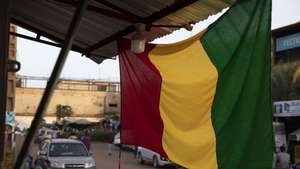epa10214546 A Malian flag hangs from a shop on a street in central Bamako, Mali, 29 September 2022.  An Economic Community of West African States (ECOWAS) delegation visited Bamako 29 September 2022 in an effort to mediate a diplomatic row which has erupted over 46 Ivorian soldiers that have been detained in Mali. Mali's junta claims they had flown in without permission and were seen as mercenaries.  EPA/HADAMA DIAKITE
