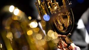 epaselect epa04479492 A person plays a baritone saxophone to celebrate the 200th birthday of saxophone inventor, Belgian Adolphe Sax in Dinant, Belgium, 06 November 2014. A son of an instrument designer and a clarinet player himself, Adolphe Sax (born 06 November 1814, died 7 February 1894) developped the saxophone in the 1840s mainly to have an improvement of the clarinet. First used in military bands and some classical pieces, the saxophone is essential nowadays in contemporary pop music and jazz.  EPA/STEPHANIE LECOCQ