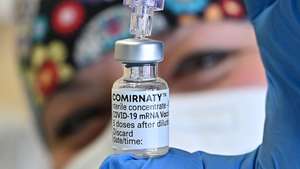 epa09108664 A health personel shows a vial of BioNTech, Fosun Pharma, Pfizer Covid-19 vaccine Comirnaty at Molinette hospital in Turin, Italy, 31 March 2021.  EPA/ALESSANDRO DI MARCO