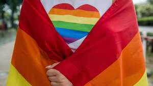 epa06871924 A participant wraped in a rainbow-coloured flag participates in the Budapest Pride march of the LGBT community in Budapest, Hungary, 07 July 2018.  EPA/ZOLTAN BALOGH HUNGARY OUT