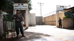 epa09381769 Afghan security officials stand guard outside the UN office in Herat, Afghanistan, 31 July 2021. The United Nations office in Afghanistan's western Herat province was attacked by "anti-government elements" on 30 July, who killed one Afghan security guard while many officials have been injured, the organization reported. The area where the UN compound is situated in Herat witnessed intense fighting between the Taliban and Afghan security forces on 30 July.  EPA/JALIL REZAYEE